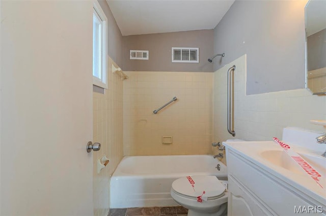5 Little Ln, Florissant, MO 63033 - bathroom featuring bathing tub / shower combination, toilet, vanity, and tile walls