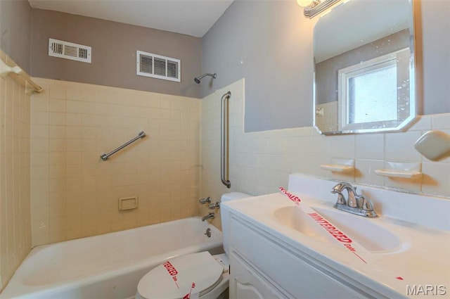 5 Little Ln, Florissant, MO 63033 - full bath featuring shower / tub combination, toilet, vanity, and tile walls