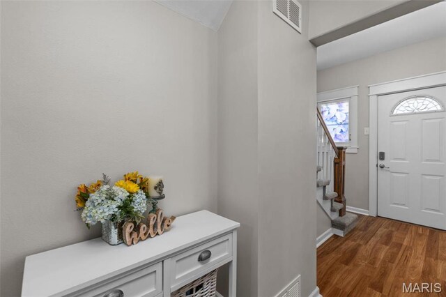 5839 W Park Ave, Saint Louis, MO 63110 - entryway with stairs, wood finished floors, and baseboards