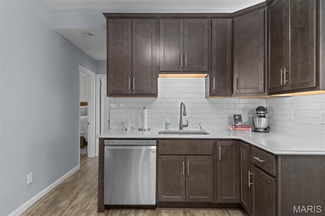 5839 W Park Ave, Saint Louis, MO 63110 - kitchen featuring dishwasher, a sink, baseboards, and backsplash