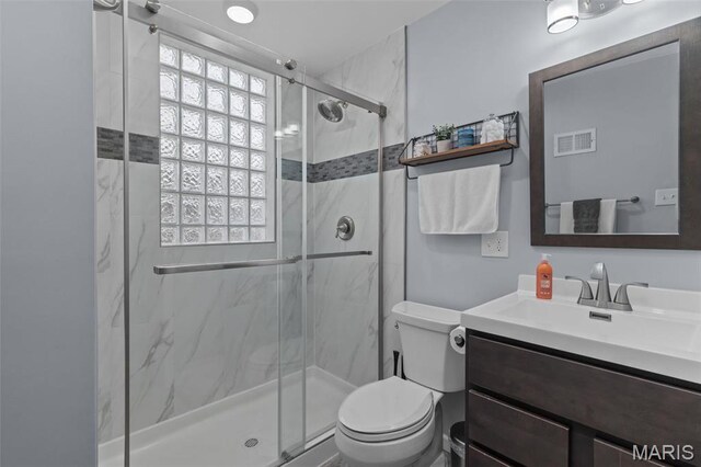 5839 W Park Ave, Saint Louis, MO 63110 - full bathroom with toilet, a marble finish shower, and vanity