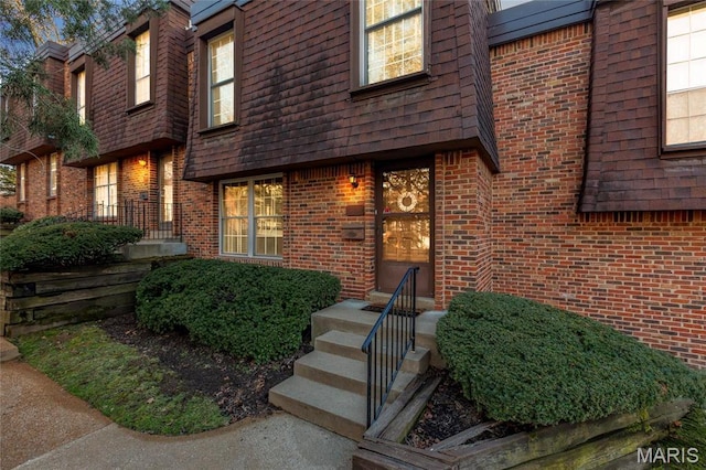13459 Coliseum Dr, Chesterfield, MO 63017 - doorway to property with brick siding and mansard roof