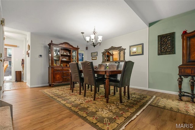 13459 Coliseum Dr, Chesterfield, MO 63017 - dining area featuring a chandelier and light wood-style flooring