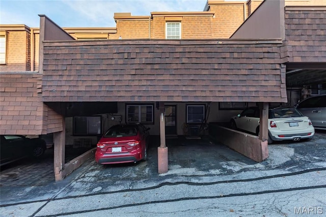 13459 Coliseum Dr, Chesterfield, MO 63017 - view of home's exterior featuring covered parking and a shingled roof