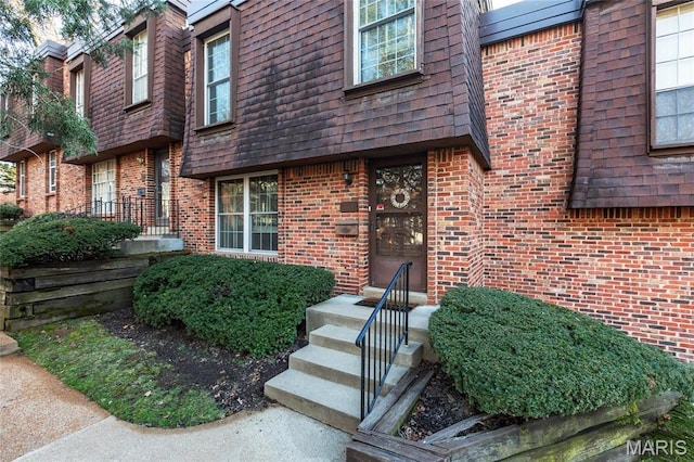13459 Coliseum Dr, Chesterfield, MO 63017 - doorway to property featuring brick siding, mansard roof, and roof with shingles