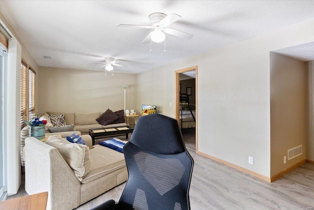 29420 Park Ave, Gravois Mills, MO 65037 - living room featuring light wood-type flooring, a ceiling fan, and baseboards