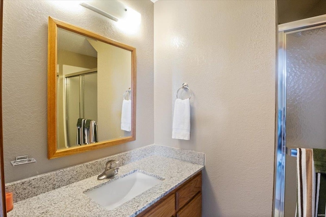 29420 Park Ave, Gravois Mills, MO 65037 - bathroom featuring a stall shower, vanity, and a textured wall