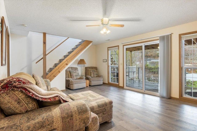 29422 Park Ave, Gravois Mills, MO 65037 - living area featuring wood finished floors, healthy amount of natural light, ceiling fan, stairway, and a textured ceiling