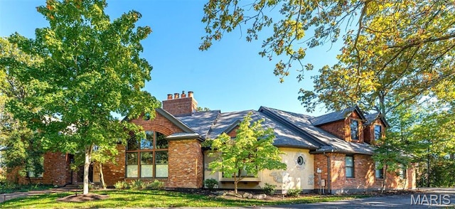16 Holiday Ln, Saint Louis, MO 63131 - view of front facade featuring brick siding and a chimney