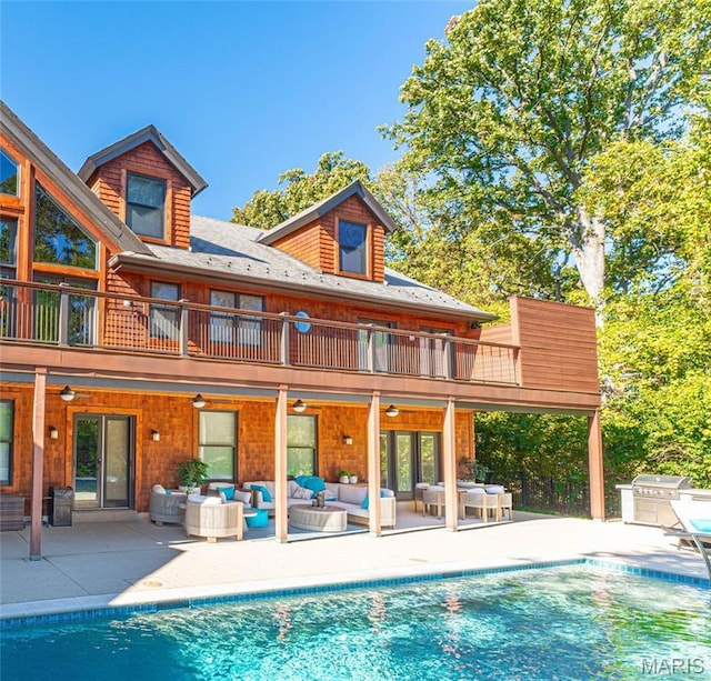 16 Holiday Ln, Saint Louis, MO 63131 - rear view of property with an outdoor hangout area, a ceiling fan, a balcony, and an outdoor pool