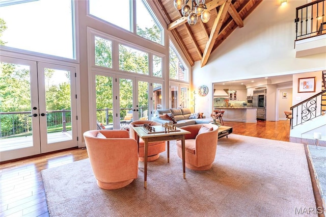16 Holiday Ln, Saint Louis, MO 63131 - living area featuring french doors, high vaulted ceiling, wooden ceiling with exposed beams, stairway, and a chandelier