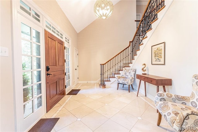 16 Holiday Ln, Saint Louis, MO 63131 - foyer entrance with stairway, vaulted ceiling, light tile patterned flooring, baseboards, and a chandelier