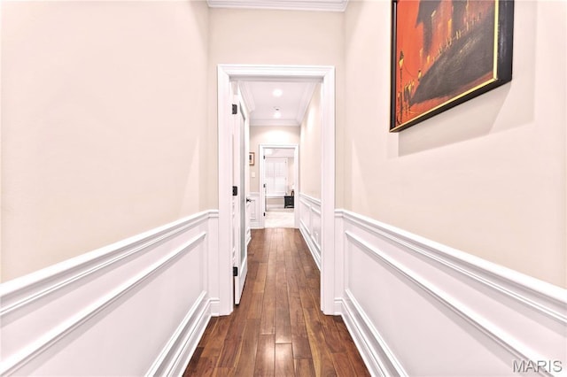 16 Holiday Ln, Saint Louis, MO 63131 - hallway with crown molding, wainscoting, dark wood-style floors, and a decorative wall