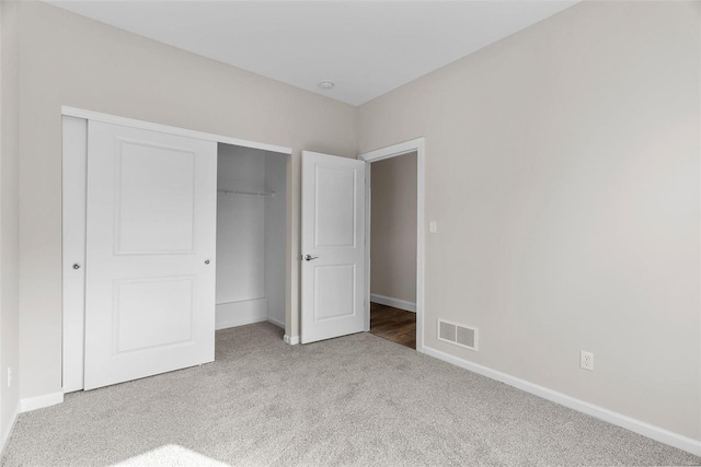 unfurnished bedroom featuring carpet floors, a closet, and baseboards