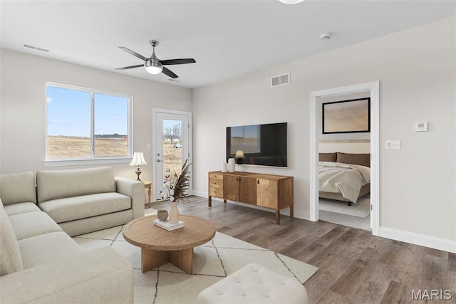 891 Walter Way, Washington, MO 63090 - living room featuring wood finished floors, a ceiling fan, and baseboards