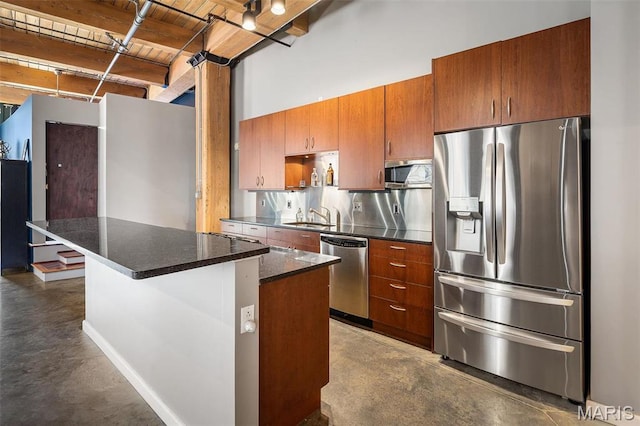 901 Washington Ave Unit 304, Saint Louis, MO 63101 - kitchen with stainless steel appliances, finished concrete flooring, brown cabinetry, and dark countertops