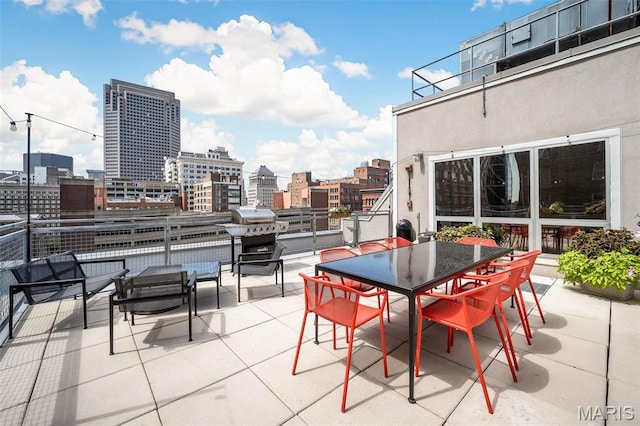 901 Washington Ave Unit 304, Saint Louis, MO 63101 - view of patio / terrace with a view of city, outdoor dining area, and area for grilling