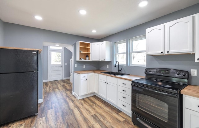 120 E Charles St, St James, MO 65559 - kitchen featuring black appliances, a sink, butcher block countertops, white cabinetry, and plenty of natural light