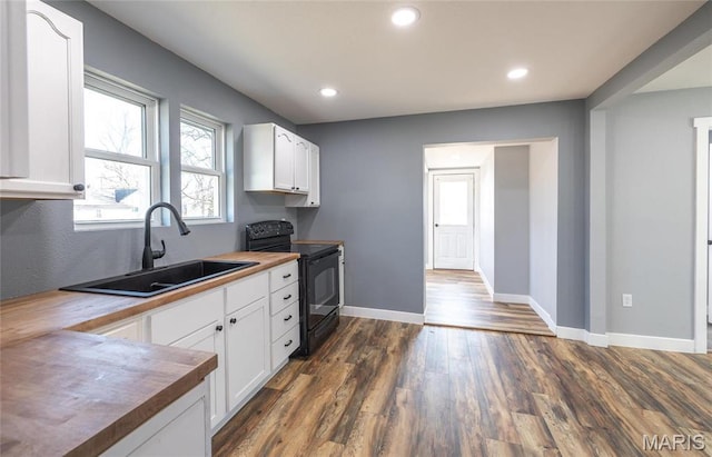 120 E Charles St, St James, MO 65559 - kitchen featuring black range with electric cooktop, dark wood-type flooring, white cabinetry, recessed lighting, and butcher block counters