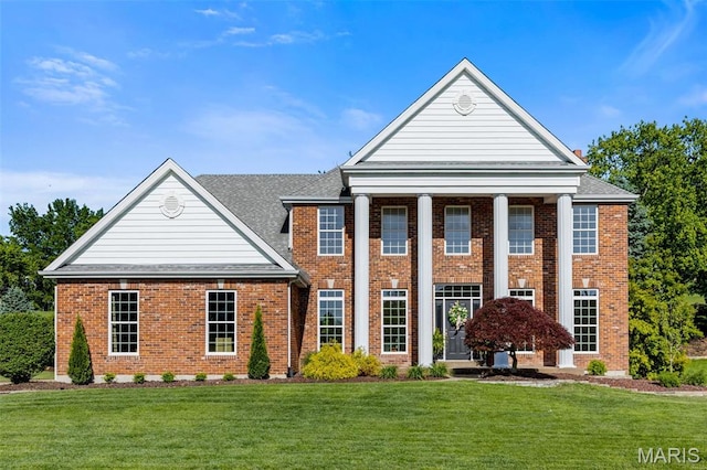 851 Whitmoor Dr, Weldon Spring, MO 63304 - greek revival house with brick siding, a front lawn, and a shingled roof