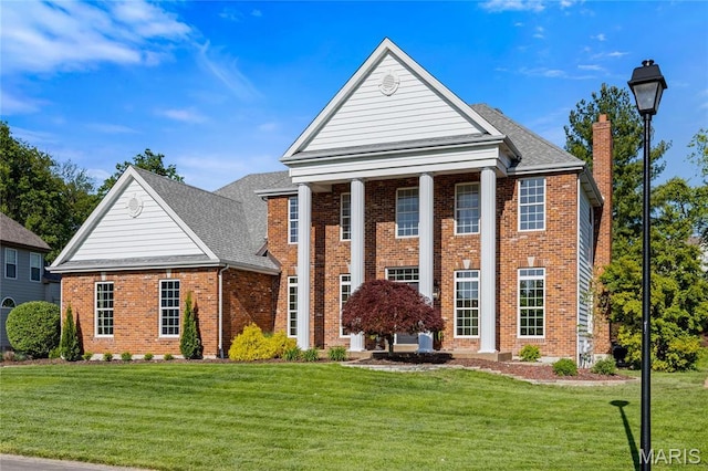 851 Whitmoor Dr, Weldon Spring, MO 63304 - greek revival inspired property featuring brick siding, a front yard, a chimney, and roof with shingles