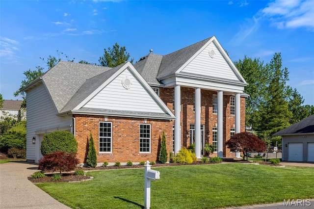 851 Whitmoor Dr, Weldon Spring, MO 63304 - neoclassical home featuring a garage, brick siding, a front yard, and a shingled roof