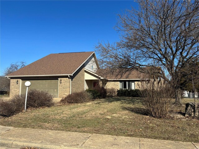 809 Cambridge Dr, Rolla, MO 65401 - view of property exterior featuring brick siding, an attached garage, a yard, and roof with shingles