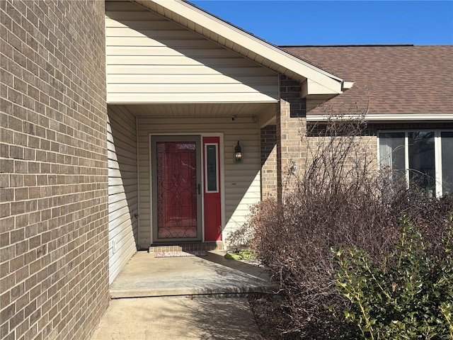 809 Cambridge Dr, Rolla, MO 65401 - view of exterior entry with a shingled roof and brick siding