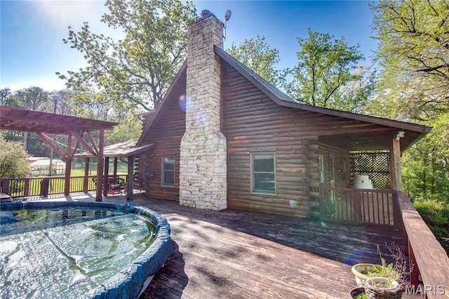 40 Country Ln, Wood River, IL 62095 - view of home's exterior with a pergola, log exterior, a wooden deck, and a chimney
