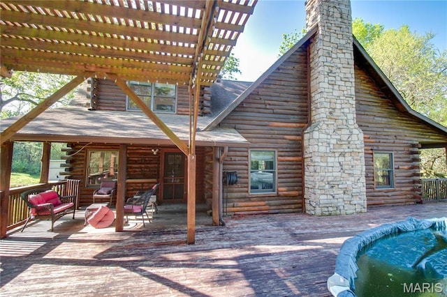 40 Country Ln, Wood River, IL 62095 - back of house with log exterior, a wooden deck, a chimney, and a pergola