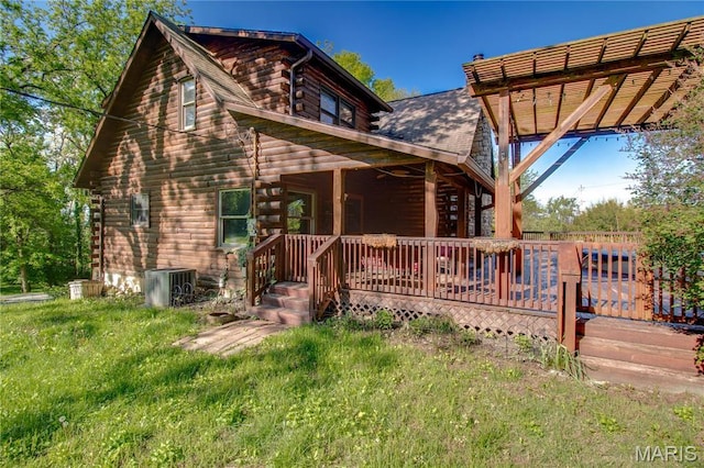 40 Country Ln, Wood River, IL 62095 - cabin with log siding, central AC, a deck, and a pergola