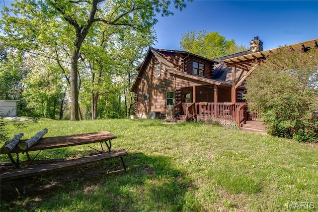 40 Country Ln, Wood River, IL 62095 - rear view of house with a lawn, a wooden deck, log siding, and a chimney