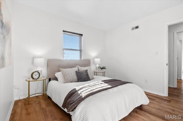 704 Soulard St Unit 704, Saint Louis, MO 63104 - bedroom featuring wood finished floors and baseboards