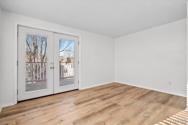 704 Soulard St Unit 704, Saint Louis, MO 63104 - unfurnished room featuring french doors, wood finished floors, and baseboards