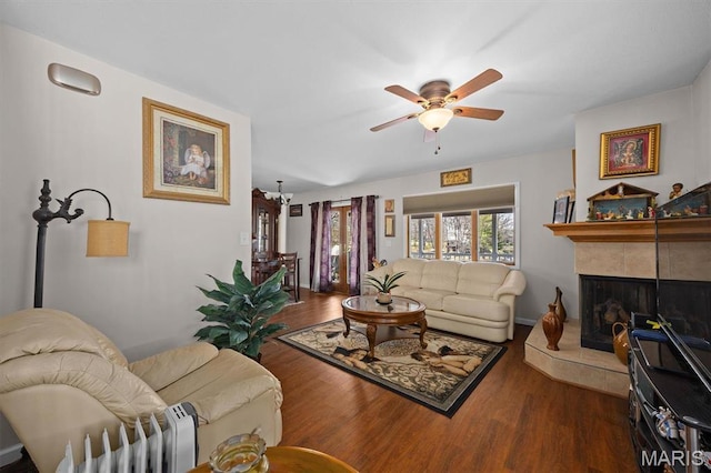 10949 Clearwater Ln, Plainview, IL 62685 - living area with ceiling fan, wood finished floors, and a tiled fireplace