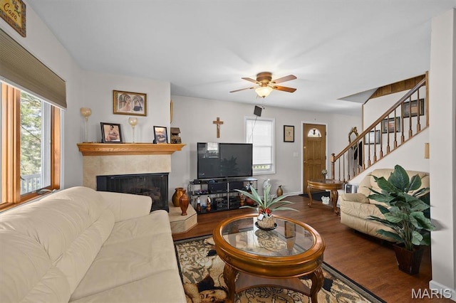 10949 Clearwater Ln, Plainview, IL 62685 - living room with healthy amount of natural light, a tile fireplace, wood finished floors, and stairway