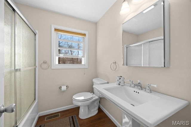 10949 Clearwater Ln, Plainview, IL 62685 - bathroom with wood finished floors, baseboards, toilet, and a sink