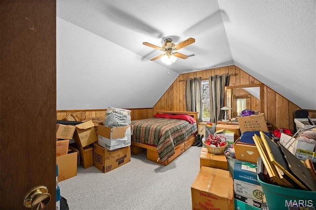 10949 Clearwater Ln, Plainview, IL 62685 - bedroom featuring wood walls, lofted ceiling, carpet floors, a textured ceiling, and a ceiling fan