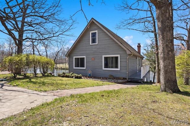 10949 Clearwater Ln, Plainview, IL 62685 - view of home's exterior featuring a chimney and a yard