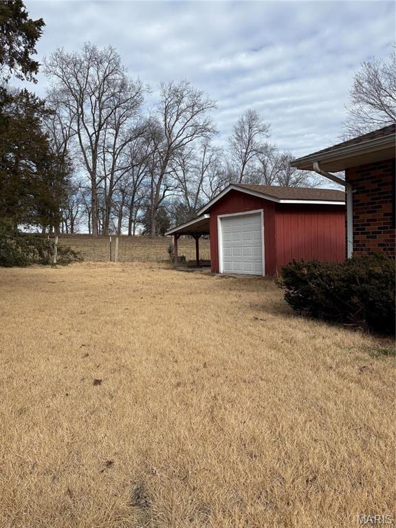 10019 Seabourne St, Belgrade, MO 63622 - view of grassy yard featuring a detached garage, an outdoor structure, and driveway