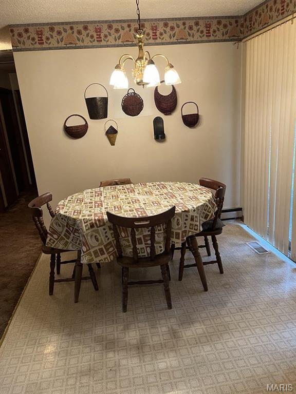 10019 Seabourne St, Belgrade, MO 63622 - dining room with a chandelier and a textured ceiling
