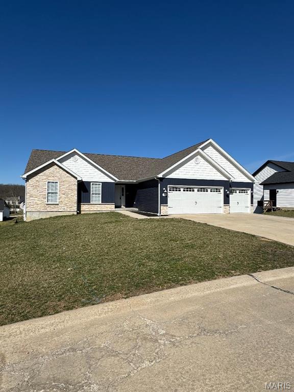 209 Auburn Ridge Dr, Troy, MO 63379 - ranch-style house with an attached garage, a front yard, driveway, and stone siding