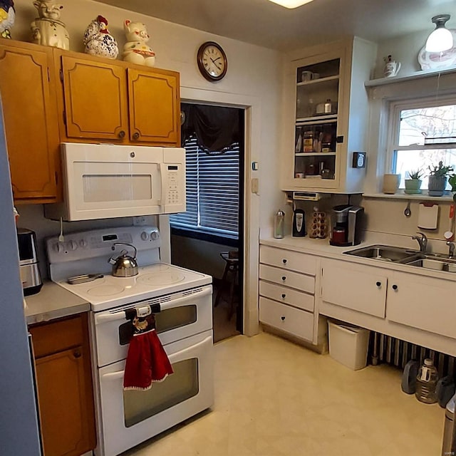2106 Lackland Rd, Saint Louis, MO 63114 - kitchen with white appliances, a sink, light countertops, light flooring, and glass insert cabinets