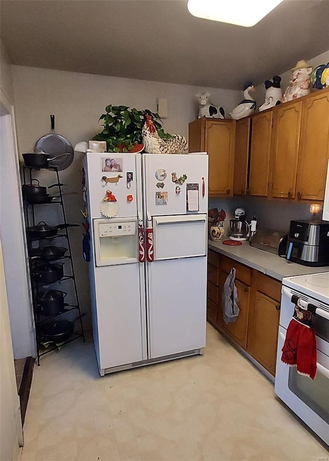 2106 Lackland Rd, Saint Louis, MO 63114 - kitchen with white appliances, brown cabinets, light floors, and light countertops