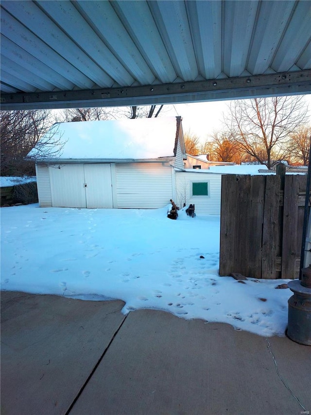 2106 Lackland Rd, Saint Louis, MO 63114 - yard layered in snow featuring fence and an outdoor structure