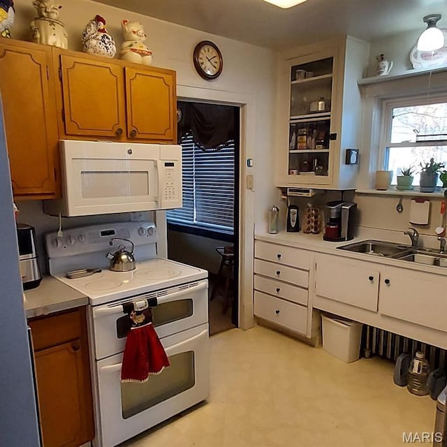2106 Lackland Rd, Saint Louis, MO 63114 - kitchen with white appliances, light countertops, light flooring, and glass insert cabinets