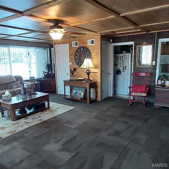 2106 Lackland Rd, Saint Louis, MO 63114 - living area with wood walls, plenty of natural light, ceiling fan, and carpet