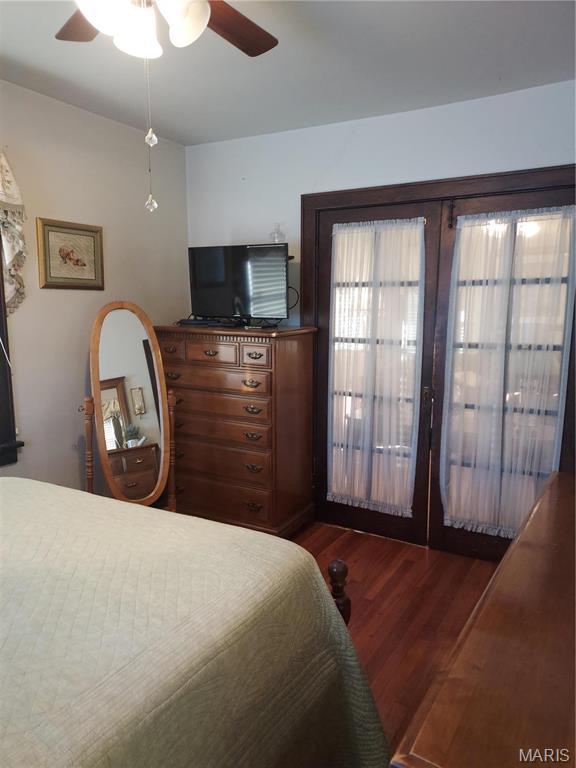 2106 Lackland Rd, Saint Louis, MO 63114 - bedroom with wood finished floors, french doors, and ceiling fan
