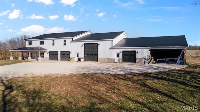284 Ridge Rd, Oak Ridge, MO 63769 - view of front of home featuring stone siding, driveway, and a front yard