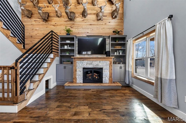 284 Ridge Rd, Oak Ridge, MO 63769 - unfurnished living room featuring stairs, dark wood-type flooring, baseboards, and wood walls